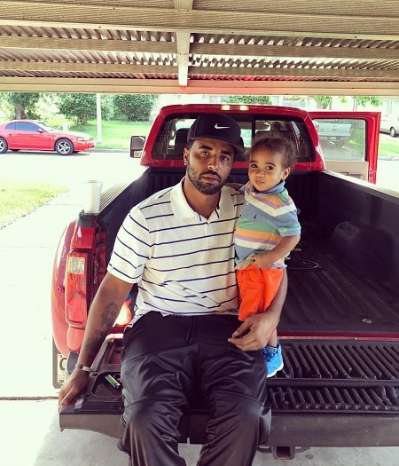 A picture of Daniel Smith carrying his son Legend Smith.